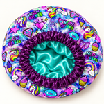 Digital product mockup: Unicorn Galaxy satin-lined bonnet with deep purple gathered band and turquoise lining.
