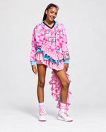 Pink Encore ruffle dress and matching bomber jacket with pink geometric print, blue accents, and a cascading ruffle train.